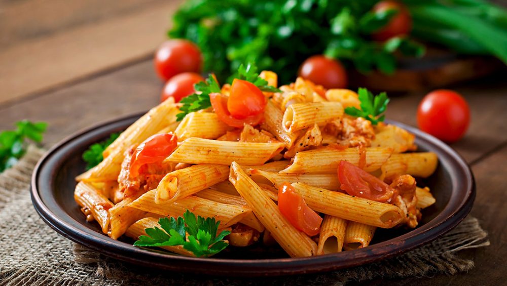 penne-pasta-tomato-sauce-with-chicken-tomatoes-wooden-table